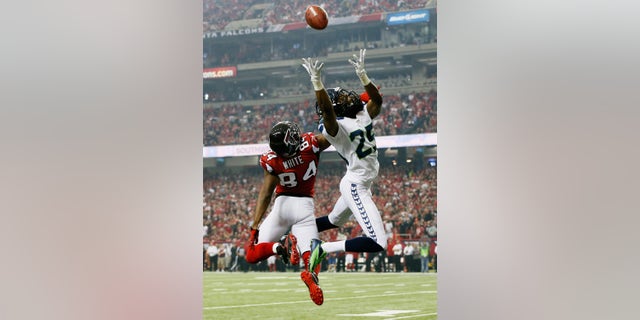 Richard Sherman # 25 of the Seattle Seahawks breaks a pass intended for Roddy White # 84 of the Atlanta Falcons during the NFC Divisional Playoff Game at Georgia Dome on January 13, 2013 in Atlanta, Georgia.  (Photo by Kevin C. Cox / Getty Images)