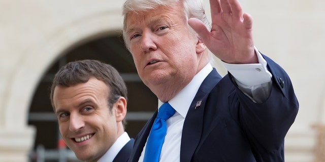French President Emmanuel Macron (L) and U.S. President Donald Trump (R) speak as they leave Les Invalides museum in Paris, France, July 13, 2017. REUTERS/Ian Langsdon/Pool - RTX3BBS6