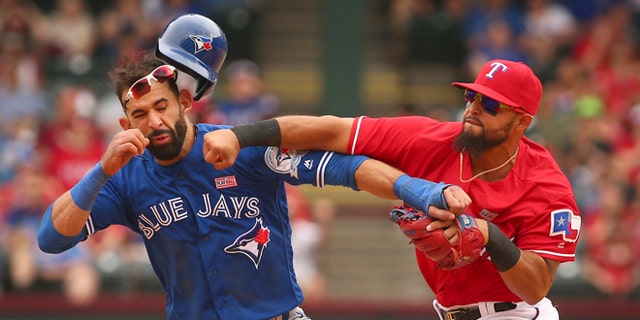 Toronto Blue Jays Jose Bautista (19) gets hit by Texas Rangers second baseman Rougned Odor (12) after Bautista slid into second in the eighth inning of a baseball game at Globe Life Park in Arlington, Texas, Sunday May 15, 2016. (Richard W. Rodriguez/Star-Telegram via AP)