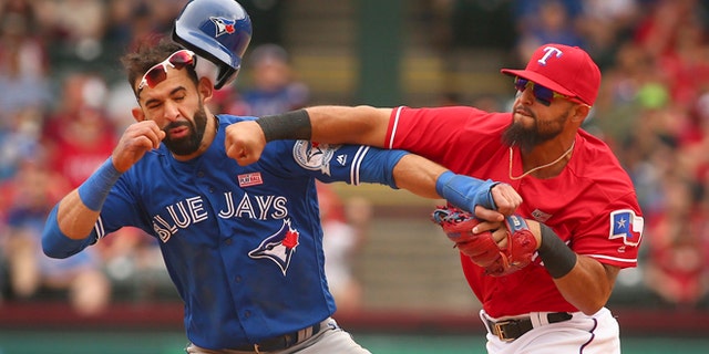 Toronto Blue Jays Jose Bautista (19) gets hit by Texas Rangers second baseman Rougned Odor (12) after Bautista slid into second in the eighth inning of a baseball game at Globe Life Park in Arlington, Texas, Sunday May 15, 2016. (Richard W. Rodriguez/Star-Telegram via AP)