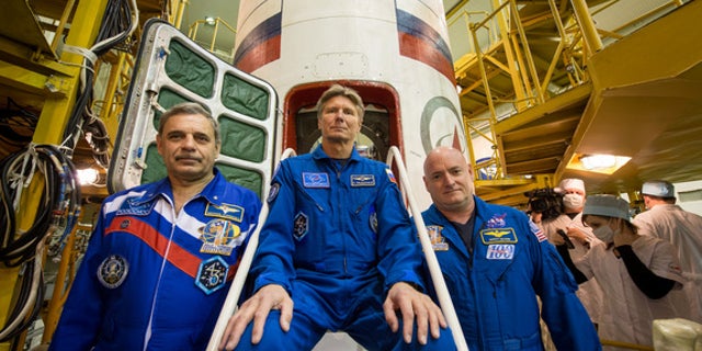 NASA's Scott Kelly (right) and cosmonaut Mikhail Kornienko (left) will fly to the International Space Station for a yearlong stay in space on March 27, 2015. Cosmonaut Gennady Padalka (center) will join them on the station for about six months.