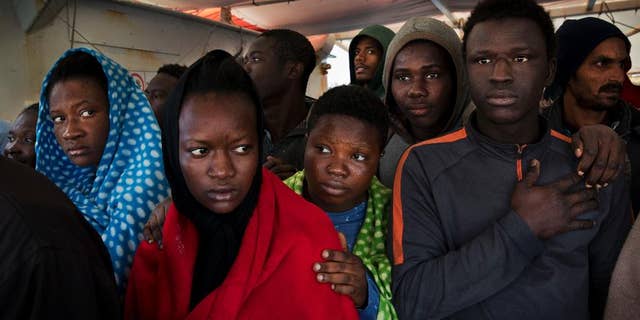 FILE - In this April 8, 2017 file photo, migrants aboard the Golfo Azurro rescue vessel wait to be transferred to Italian authorities in Trapani harbor, in the Italian island of Sicily. Most, though, don't understand that this could be just one more step in an impossible dream. Many are sent to government-run migrant camps. Others, depending on international agreements, are sent back home. (AP Photo/Bernat Armangue, File)