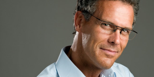 Handsome mature man looking at camera with a pair of modern glasses