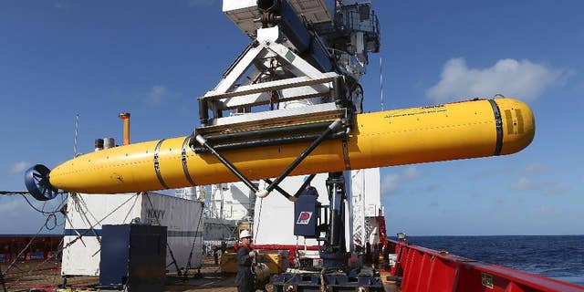 In this Thursday, April 17, 2014 photo provided by the Australian Defense Force the Phoenix International Autonomous Underwater Vehicle (AUV) Artemis is craned over the side of Australian Defense Vessel Ocean Shield before launching the vehicle into the southern Indian Ocean in the search of the missing Malaysia Airlines Flight 370. Up to 11 aircraft and 12 ships continue to scan the ocean surface for debris from the Boeing 777 that disappeared March 8 en route from Kuala Lumpur to Beijing with 239 people on board. (AP Photo/Australian Defense Force, Bradley Darvill) EDITORIAL USE ONLY