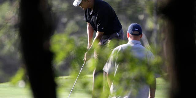 Friday: President Obama prepares to putt while playing golf at the Vineyard Golf Club, in Edgartown, Mass., on the island of Martha's Vineyard. The president is vacationing on the island with his family. (AP Photo)