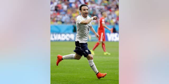 France's Mathieu Valbuena celebrates after scoring his side's third goal during the group E World Cup soccer match between Switzerland and France at the Arena Fonte Nova in Salvador, Brazil, Friday, June 20, 2014. (AP Photo/Natacha Pisarenko)