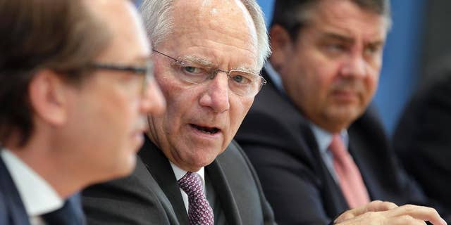 From left, German Transportation Minister Alexander Dobrindt, German Finance Minister Wolfgang Schaeuble and German Minister for Economic Affairs and Energy, Sigmar Gabriel, address the media during a joint press conference in Berlin, Germany, Wednesday, April 27, 2016. Germany plans to subsidize electric cars in a bid to help the country's auto industry compete in the global market for the growingly-popular and environmentally friendly vehicles. (AP Photo/Michael Sohn)