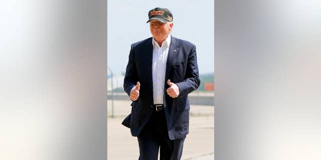 Republican presidential candidate Donald Trump gives a thumbs up as he arrives for a campaign rally, Saturday, June 11, 2016, at a private hanger at Greater Pittsburgh International Airport in Moon, Pa. (AP Photo/Keith Srakocic)