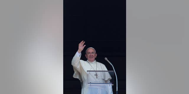 Pope Francis delivers his blessing during the Angelus noon prayer he celebrated from the window of his studio overlooking St. Peter's Square, at the Vatican, Sunday, Aug. 10, 2014. Pope Francis has expressed outrage at violence aimed at religious minorities in Iraq that has seen children die of thirst, and said his emissary would depart Rome on Monday. In a strongly worded message during his traditional Sunday blessing, Francis said the news from Iraq "leaves us in disbelief." He cited "the thousands of people, including Christians, who have been brutally forced from their homes, children who have died from thirst during the escape and women who have been seized." (AP Photo/Andrew Medichini)