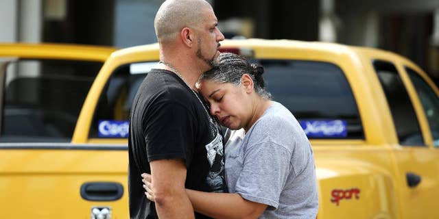 Ray Rivera, left, a DJ at Pulse Orlando nightclub, is consoled by a friend, outside of the Orlando Police Department after a shooting involving multiple fatalities at the nightclub, Sunday, June 12, 2016, in Orlando, Fla. (Joe Burbank/Orlando Sentinel via AP) MAGS OUT; NO SALES; MANDATORY CREDIT
