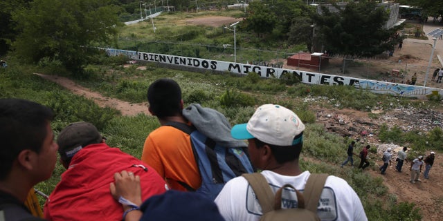 Central American immigrants arrive on top of a freight train to the Hermanos en el Camino immigrant shelter on August 6, 2013 in Ixtepec, Mexico.