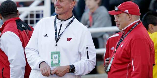 In this photo taken Jan. 1, 2013, the Wisconsin new football coach Gary Andersen, center, watches from the sidelines with deputy athletic director Sean Frazier during the Rose Bowl football game between the Stanford Cardinals and Wisconsin in Pasadena, Calif. Andersen came into the spring with plenty of starters returning for the three-time defending Big Ten champion Badgers. But Montee Ball is gone, and an Ohio State team that went 12-0 last season is eligible again. (AP Photo/The Wisconsin State Journal, Michael P. King)