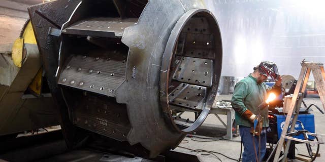 In this photo taken on Thursday, Feb. 12, 2015, a man welds parts in fans for industrial ventilation systems at the Robinson Fans Inc. plant in Harmony, Pa. The Commerce Department releases second-quarter gross domestic product on Thursday, July 30, 2015. (AP Photo/Keith Srakocic)