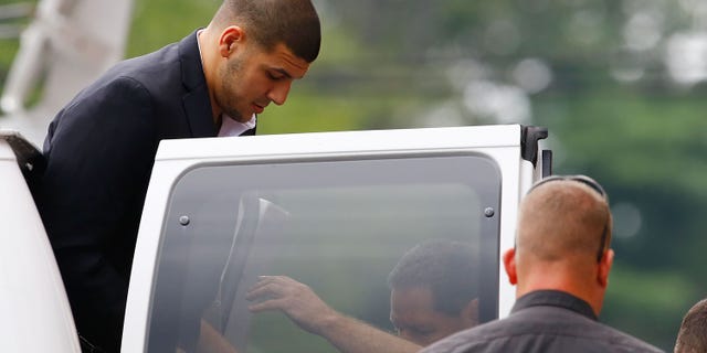 Aaron Hernandez is escorted into Attleboro District Court on August 22, 2013 in North Attleboro, Massachusetts.
