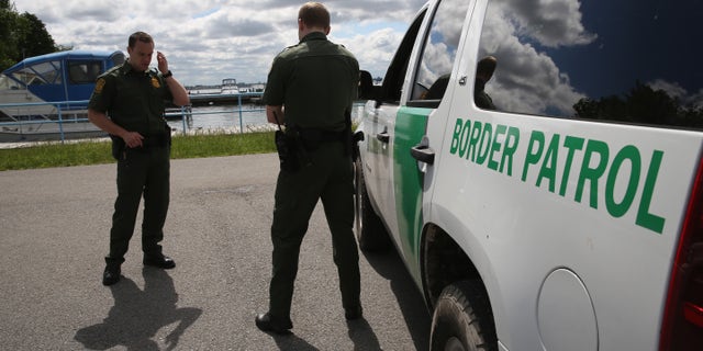 BEAVER ISLAND STATE PARK, NY - JUNE 03: U.S. Border Patrol agents talk while at a marina on the Niagara River at the U.S.-Canada border on June 3, 2013 in Beaver Island State Park, New York. U.S. Customs and Border Protection, which includes the Border Patrol, monitors the 5,525 mile long border, including Alaska, forming the longest international border between two countries in the world. (Photo by John Moore/Getty Images)