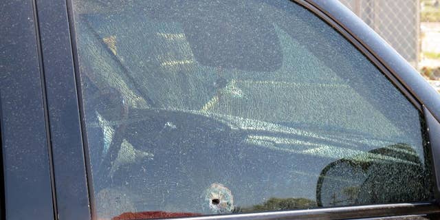 This Saturday, Aug. 29, 2015 photo provided by The Arizona Department of Public Safety shows a SUV window shattered by a gun shot in Phoenix. Authorities say shots were fired at several vehicles on Interstate 10 in Phoenix over the weekend, with bullets striking three vehicles and injuring one person. (The Arizona Department of Public Safety via AP)