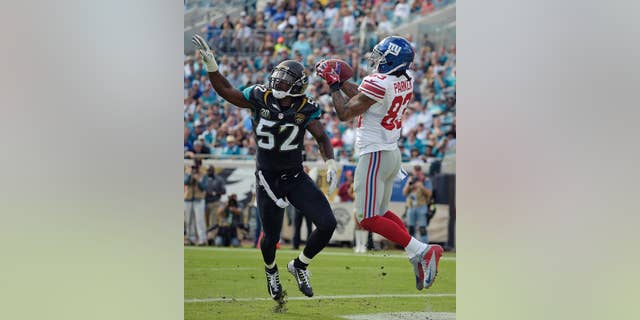 New York Giants wide receiver Preston Parker (83) catches a 3-yard touchdown pass in front of Jacksonville Jaguars outside linebacker J.T. Thomas (52) during the first half of an NFL football game in Jacksonville, Fla., Sunday, Nov. 30, 2014. (AP Photo/Phelan M. Ebenhack)