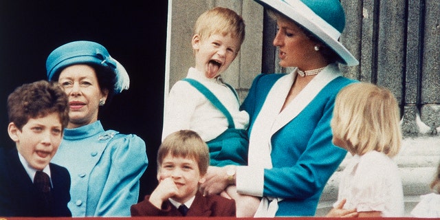 In this June 11, 1988 file photo, Britain's Prince Harry sticks out his tongue for the cameras on the balcony of Buckingham Palace in London.
