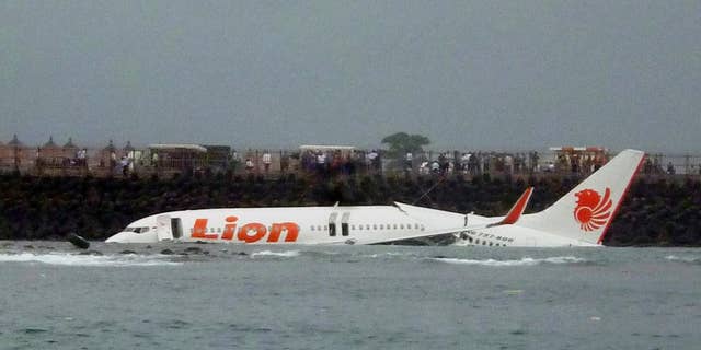 FILE - In this Saturday, April 13, 2013, file photo, the wreckage of a Lion Air plane sits on the water near the airport in Bali, Indonesia. The head of Indonesia's narcotics agency says most of the country's airline accidents have involved pilots on drugs, including a Lion Air jet that slammed into the sea four years ago while trying to land on Bali. Budi Waseso made the comments Thursday at a ceremony inaugurating Bali's traditional village security guards as anti-drug volunteers. (AP Photo)