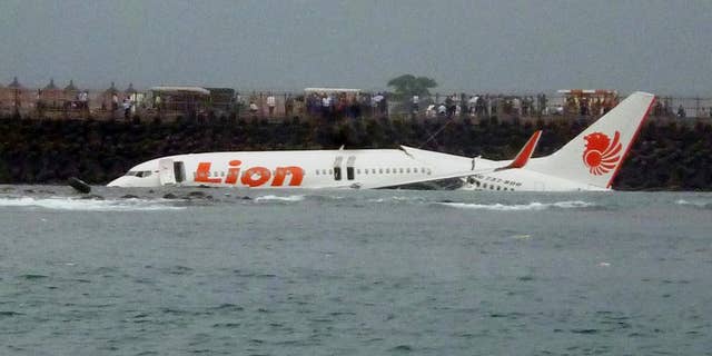 FILE - In this Saturday, April 13, 2013, file photo, the wreckage of a Lion Air plane sits on the water near the airport in Bali, Indonesia. The head of Indonesia's narcotics agency says most of the country's airline accidents have involved pilots on drugs, including a Lion Air jet that slammed into the sea four years ago while trying to land on Bali. Budi Waseso made the comments Thursday at a ceremony inaugurating Bali's traditional village security guards as anti-drug volunteers. (AP Photo)