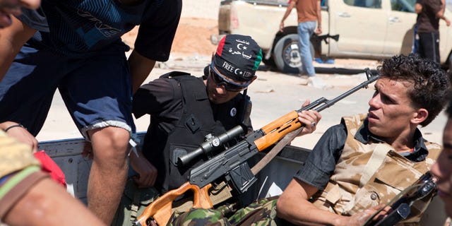 Libyan rebels are seen in the back of a pick-up truck headed for the frontline near Zawiya in western Libya, Saturday, Aug. 13, 2011.