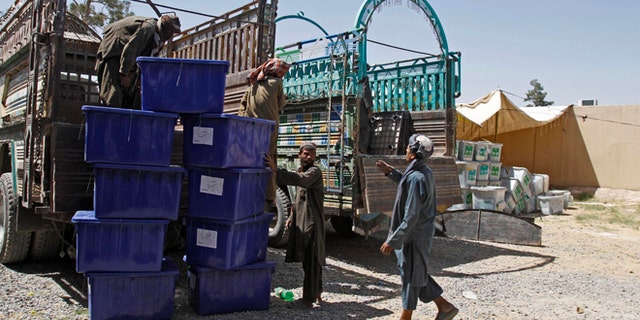 June 12, 2014: Afghan election workers load ballot boxes and election materials into trucks to deliver to polling stations, at a warehouse in Kandahar, Afghanistan. (AP)