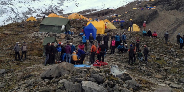 Sept. 23, 2012: In this photo provided by Nepalese airline Simrik Air, rescuers attend to injured victims, unseen, after an avalanche at the base camp of Mount Manaslu in northern Nepal.