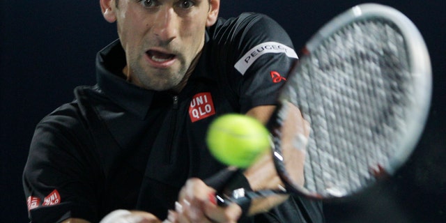 Novak Djokovic of Serbia returns the ball to Spain's Roberto Bautista Agut during the third day of the Dubai Tennis Championships in Dubai, United Arab Emirates, Wednesday, Feb. 26, 2014. (AP Photo/Kamran Jebreili)