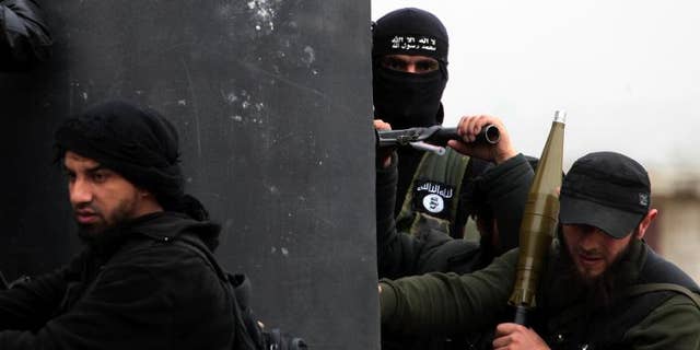 Jihadist militants with the Al-Nusra Front patrol the Syrian village of Aziza, on April 4, 2013