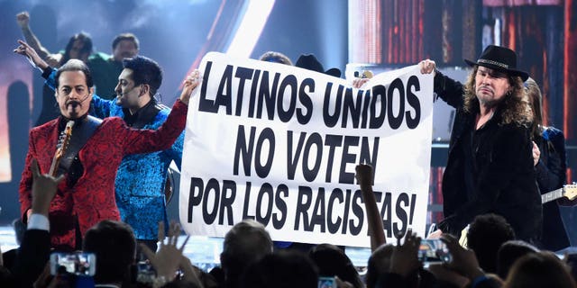 LAS VEGAS, NV - NOVEMBER 19: Members of the music groups Mana and Los Tigres Del Norte hold up a sign onstage during the 16th Latin GRAMMY Awards at the MGM Grand Garden Arena on November 19, 2015 in Las Vegas, Nevada. (Photo by Frazer Harrison/Getty Images for LARAS)