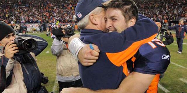 January 8, 2012: Denver Broncos quarterback Tim Tebow (15) hugs coach John Fox after the Broncos defeated the Pittsburgh Steelers 29-23 in overtime in an NFL wild card playoff football game.
