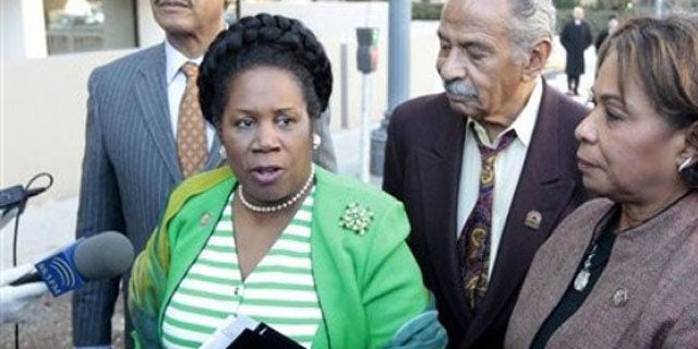 Rep. Sheila Jackson Lee, accompanied by Rep. John Conyers, center, and Rep. Barbara Lee, right, speak with reporters outside the Libyan Embassy in Washington, in this March 1, 2011 file photo.