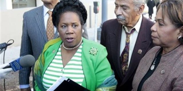 Rep. Sheila Jackson Lee, accompanied by Rep. John Conyers, center, and Rep. Barbara Lee, right, speak with reporters outside the Libyan Embassy in Washington, in this March 1, 2011 file photo.