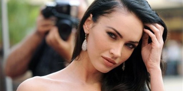 Megan Fox hit the beach flaunting her baby bump in a bikini.