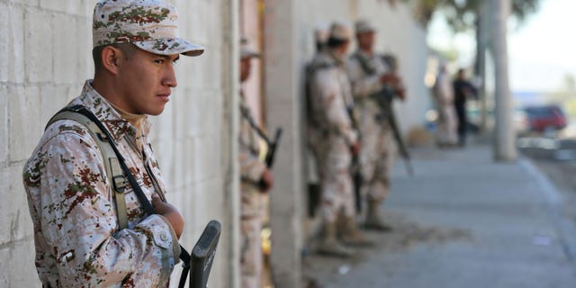 TIJUANA, MEXICO - OCTOBER 31: Mexican security officials stand guard outside of a factory where a drug tunnel was discovered leading into the United States on October 31, 2013 in Tijuana, Mexico. The tunnel was discovered last night just south of the Otay Mesa border crossing in a business park area. (Photo by Sandy Huffaker/Getty Images)