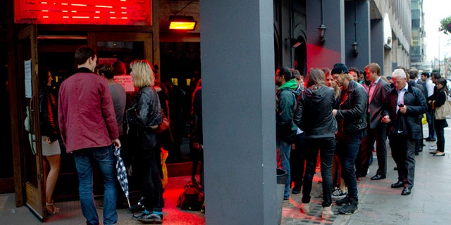 July 10, 2012: Customers form a queue as they wait to be seated in the Meat Liquor restaurant on Welbeck Street in central London.