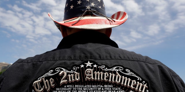 A man wears a patriotic-themed cowboy hat during a pro gun-rights rally at the state capitol, Saturday, April 14, 2018, in Austin, Texas. Gun rights supporters rallied across the United States to counter a recent wave of student-led protests against gun violence. (AP Photo/Eric Gay)