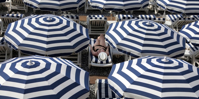 Safety tips for beach umbrellas include tilting the umbrella into the wind and anchoring the base of the pole with some weight to stabilize it.