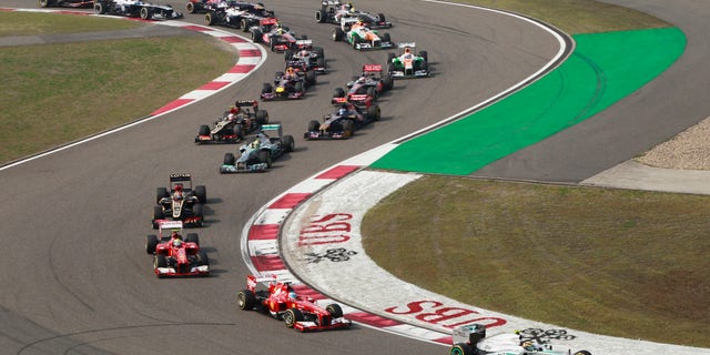 Mercedes driver Lewis Hamilton of Britain leads the field into turn three at the start of the Chinese Formula One Grand Prix in Shanghai, China, Sunday, April 14, 2013. (AP Photo/Eugene Hoshiko)