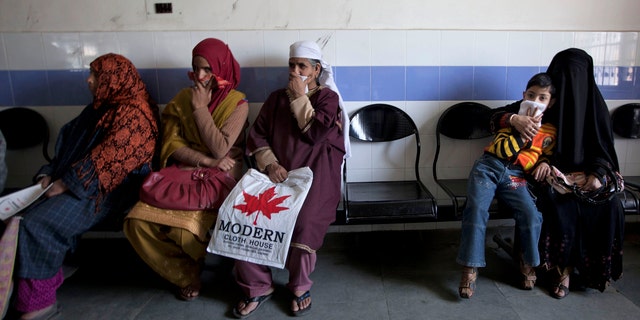 A child waits along with Kashmiri women for his turn to be examined at the Chest Disease Hospital on World Tuberculosis Day in Srinagar, India. Health officials are embarking on an ambitious plan to wipe out tuberculosis in children even though they don't know exactly how many cases there are.