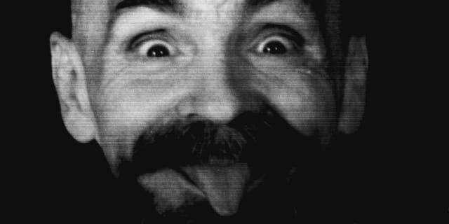 August 25, 1989: Manson clowns around as he is led to his cell upon the conclusion of his interview with Reuters.