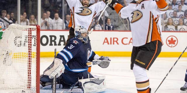 Anaheim Ducks left wing Patrick Maroon (19) and right wing Corey Perry (10) celebrate Perry's goal against Winnipeg Jets goalie Ondrej Pavelec (31) during the second period of Game 3 of the opening round of the Stanley Cup NHL hockey playoffs, Monday, April 20, 2015, in Winnipeg, Manitoba. Anaheim defeated Winnipeg 5-4 in overtime, taking a 3-0 series lead. (Michael Goulding/The Orange County Register via AP)