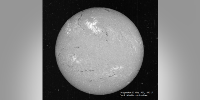 A view of the Sun on May 23, 1967, in a narrow visible wavelength of light called Hydrogen-alpha. The bright region in the top center region of brightness shows the area where the large flare occurred.