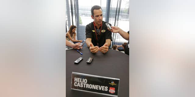 Helio Castroneves, of Brazil, responds to a question during media interview for the Indianapolis 500 IndyCar auto race at the Indianapolis Motor Speedway in Indianapolis, Thursday, May 22, 2014. (AP Photo/Darron Cummings)