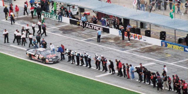 DAYTONA BEACH, FL - FEBRUARY 15: Dale Earnhardt Sr. (April 29, 1951 - February 18, 2001) driver of the #3 GM Goodwrench Chevrolet celebrates with every crew member of every team on pit road after winning the 1998 NASCAR Winston Cup Daytona 500 at the Daytona International Speedway on February 15, 1998 in Daytona Beach, Florida. (Photo by ISC Archives via Getty Images)