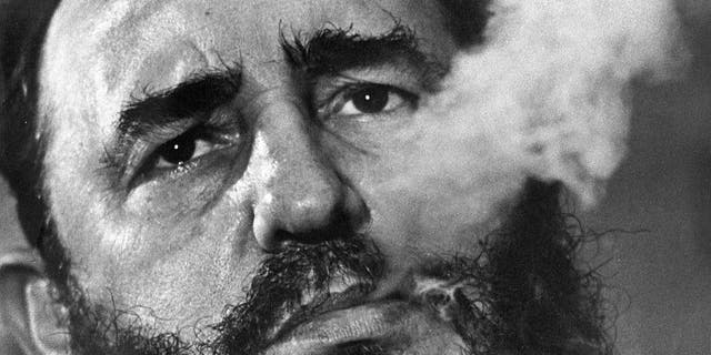 Cuba's leader Fidel Castro smokes a cigar
