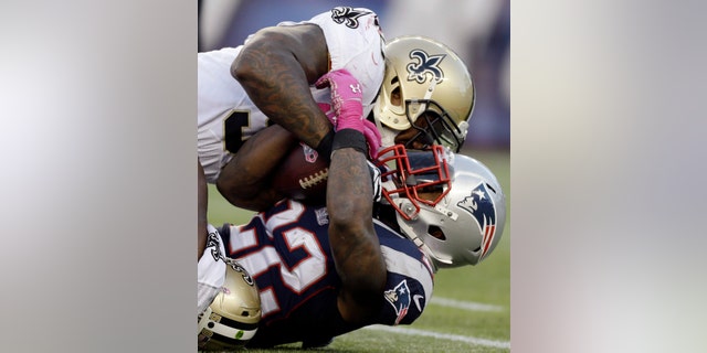 FILE - In this Oct. 13, 2013, file photo, New Orleans Saints outside linebacker Parys Haralson, top, tackles New England Patriots running back Stevan Ridley (22) in the first half of an NFL football game in Foxborough, Mass. Haralson was happy to be moving closer to family, but didn't otherwise know what to expect when he was traded from the 49ers to the Saints. Turns out his new club is in the thick of the playoff race as his old team comes to town. (AP Photo/Steven Senne, File)