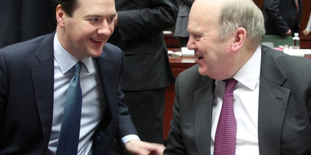 British Chancellor of the Exchequer George Osborne, left, talks with President of the EU rotating Council and Irish Finance Minister Michael Noonan during the EU finance ministers meeting, at the European Council building in Brussels, Tuesday, Feb. 12, 2013. Irish Finance Minister Michael Noonan has voiced his opposition to any proposal that the European Central Bank should intervene to get the value of the euro down. (AP Photo/Yves Logghe)