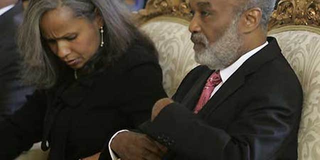 Jan. 1: Haiti's President Rene Preval sits with his wife, fist lady Elisabeth Debrosse Delatour.