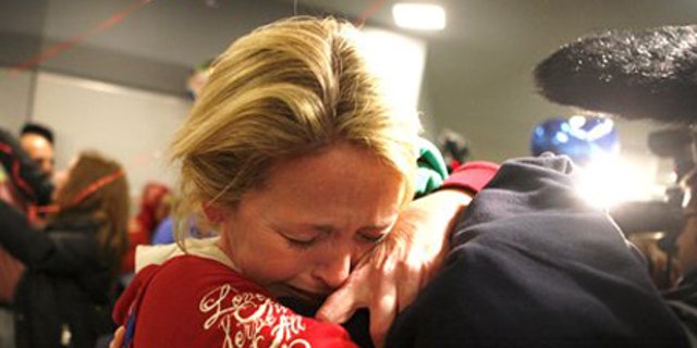 Jan. 15: Linda Callahan embraces her son as she and members of Trinity Methodist return from Haiti.